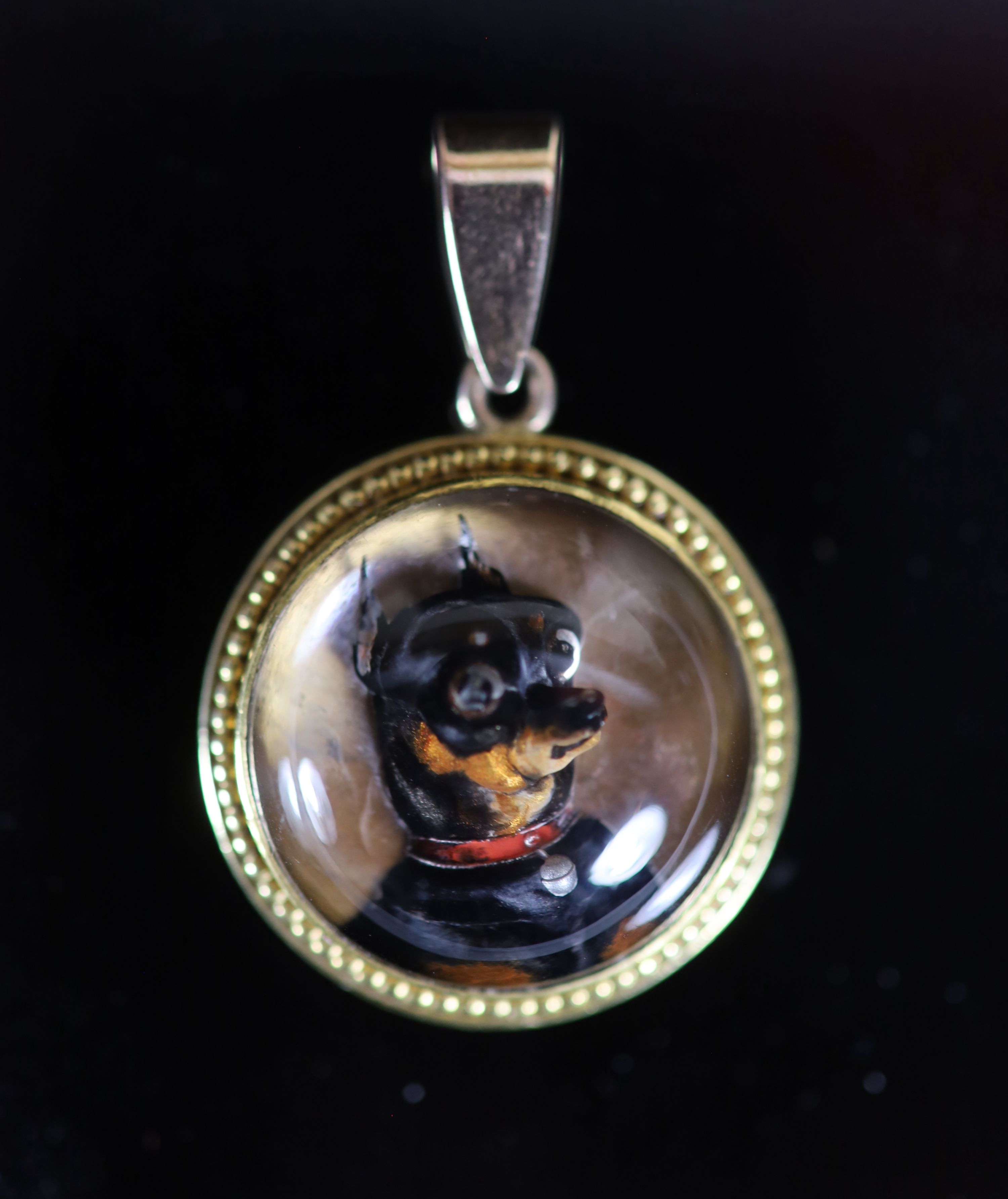 A Victorian gold mounted Essex crystal circular pendant, decorated with a terrier dog